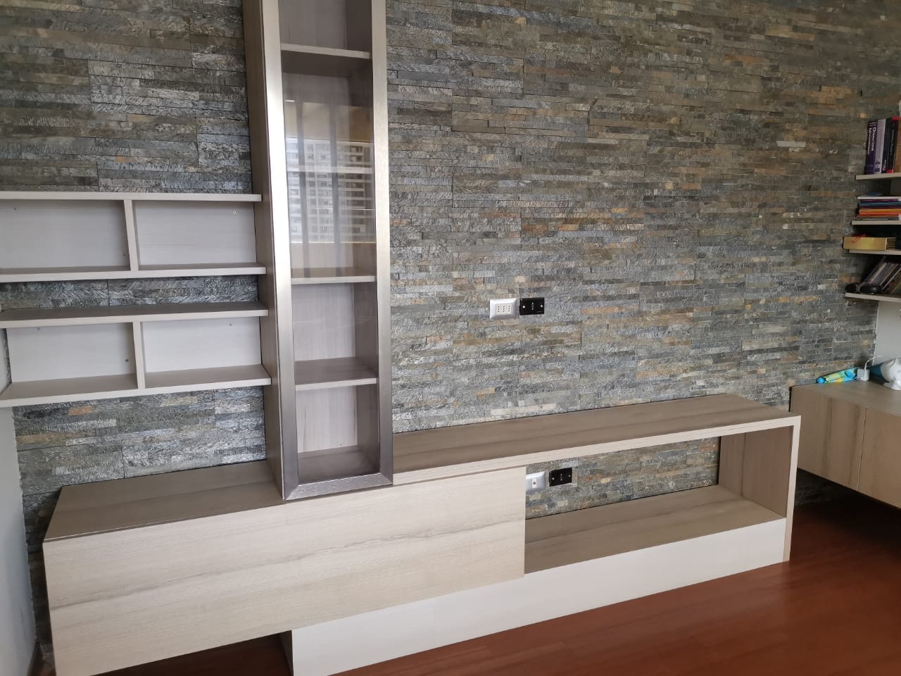 Media console against stone wall